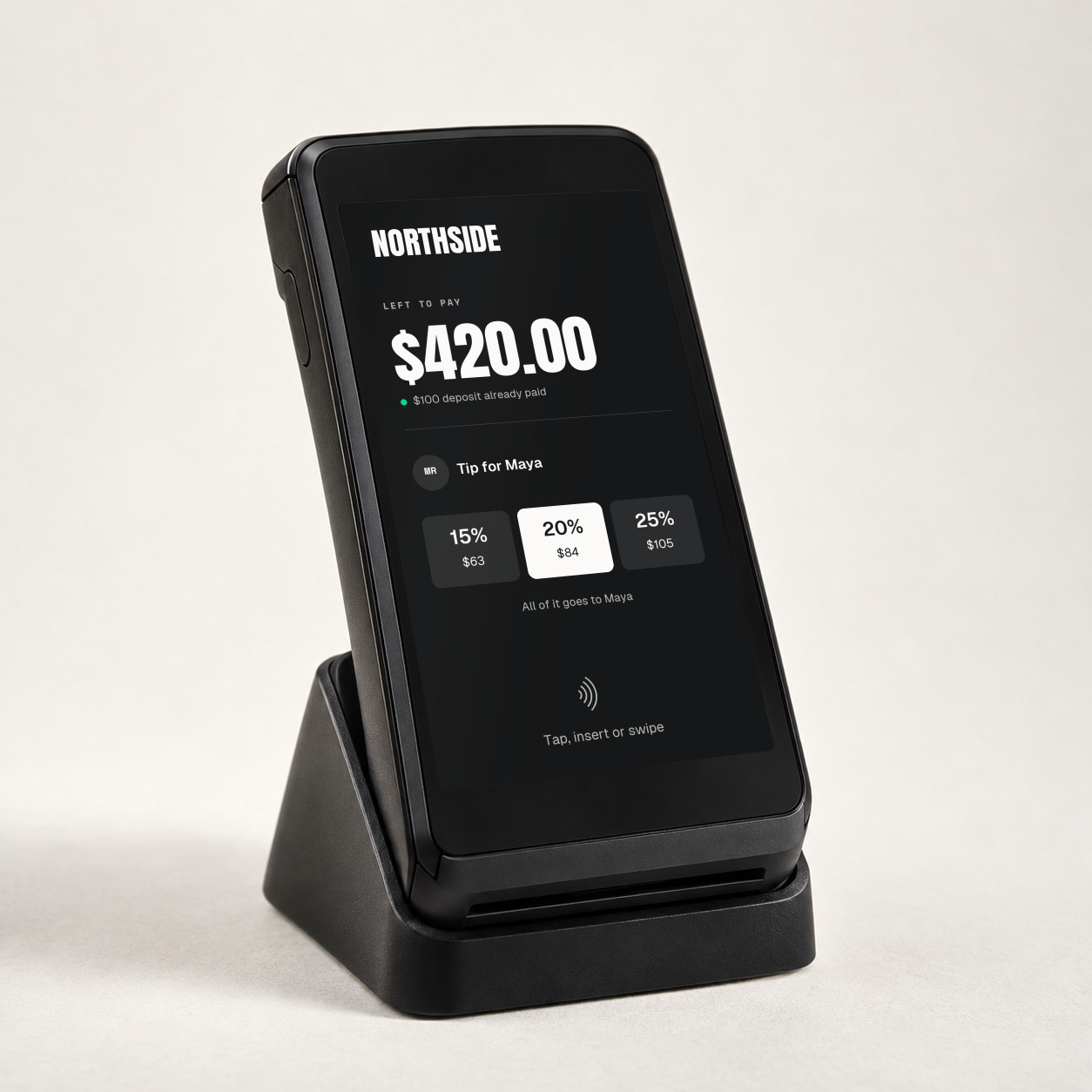 Handheld terminal in its dock showing the Studio's own tip screen